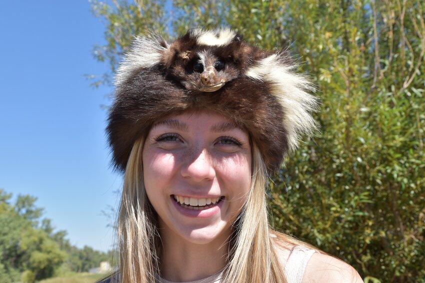 Jessica Barrington grabbed her grandpa's skunk hat from his tent at the historic Fort Lupton Trading post to wear and celebrate Fort Lupton's Trapper Days. The hat is the kind that men used to wear in the 1820s to keep their heads warm.